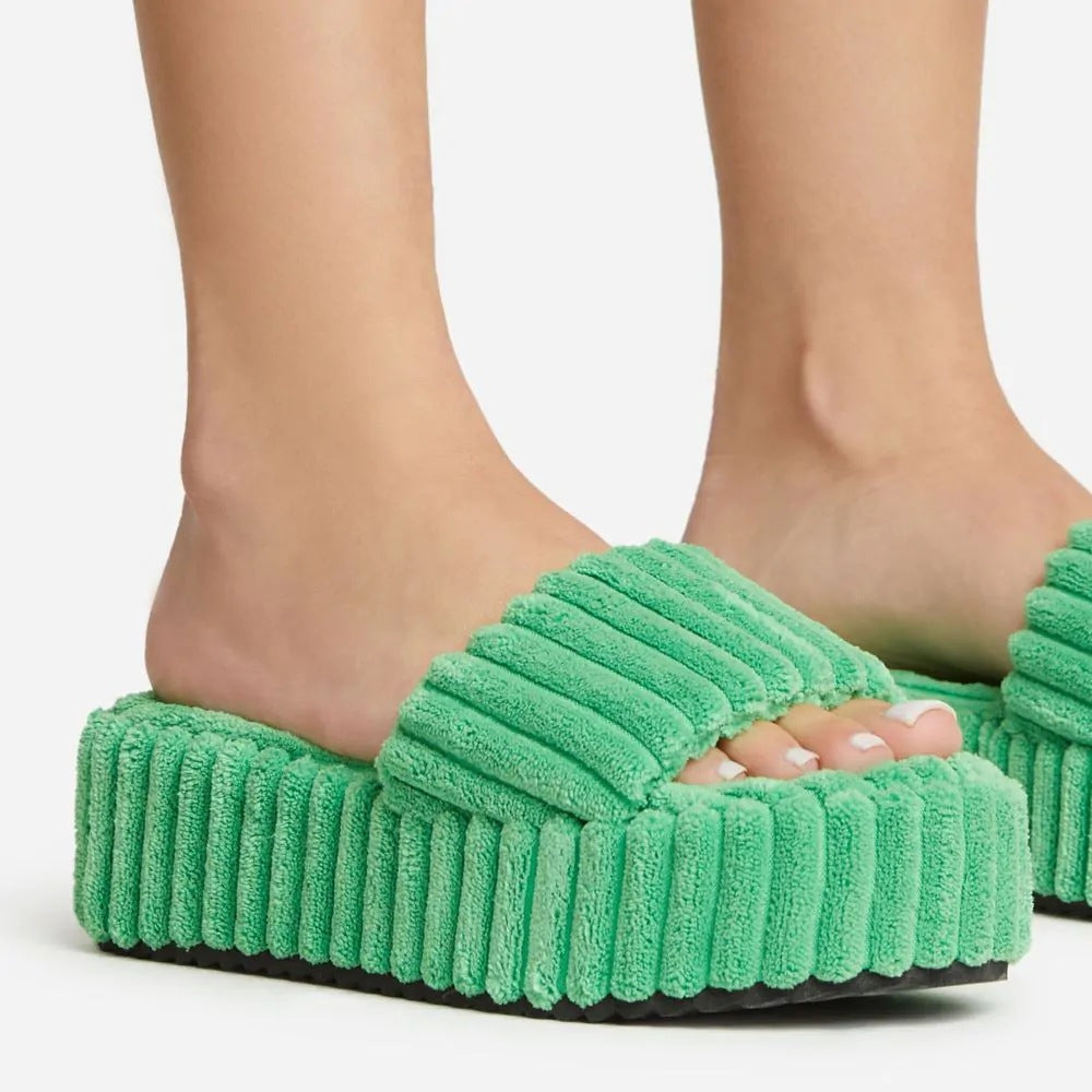Wearing Plush Slippers With A Large Thick Sole On The Outside