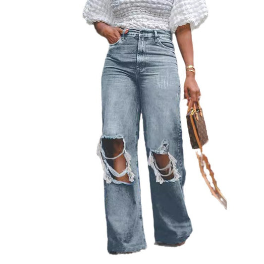 Damejeans i vasket denim med lige ben, med slidt og revnet look