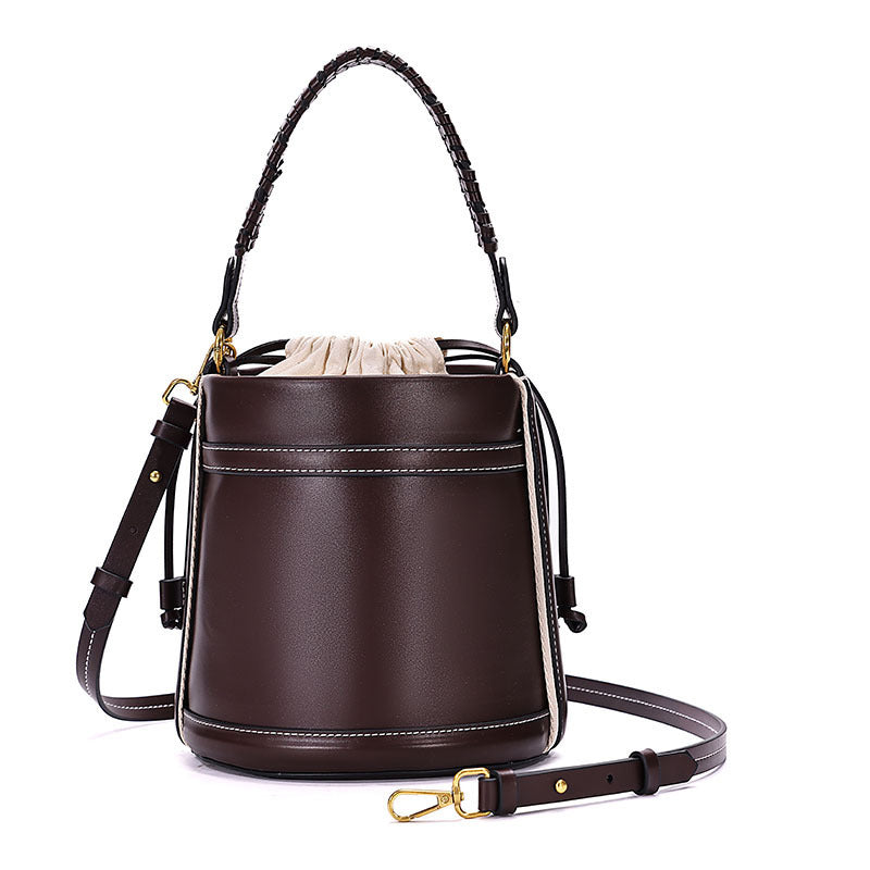 Brown Cylindrical Tote Bag With Dual Handles, Designed For Handheld Or Crossbody Wear