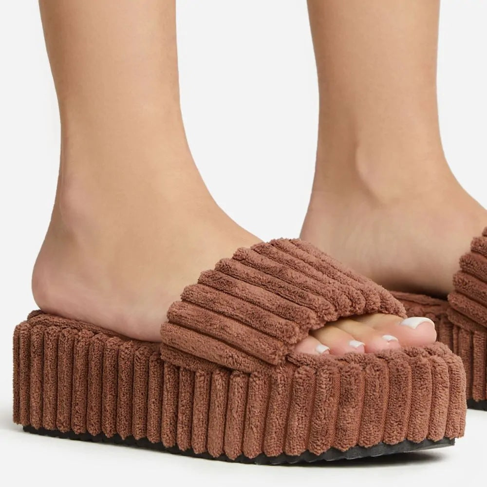 Wearing Plush Slippers With A Large Thick Sole On The Outside