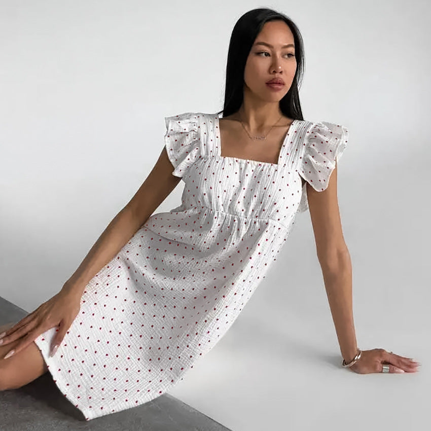 White Sleeveless Dress With Heart Print And Ruffle Trim
