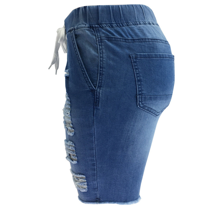 Medium-Washed Blue Jeans With Holes In The Pants