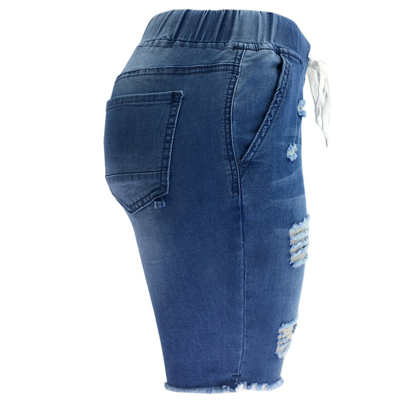 Medium-Washed Blue Jeans With Holes In The Pants