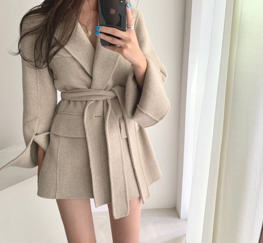 A buckle lace up waist slimming long sleeve woolen coat