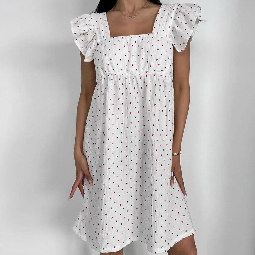White Sleeveless Dress With Heart Print And Ruffle Trim