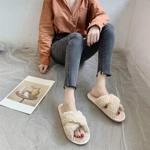 Cross hairy slippers to keep warm at home