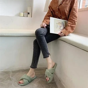 Cross hairy slippers to keep warm at home