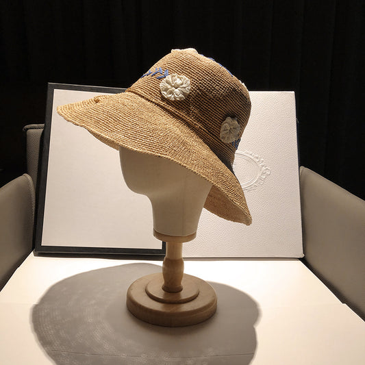 Women's Raffia Hat With Embroidered Flowers On Vacation By The Sea
