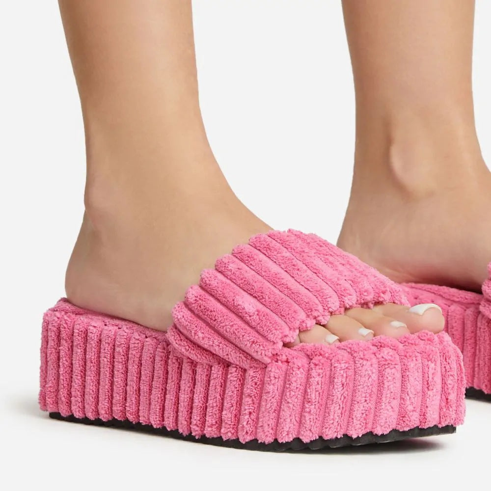 Wearing Plush Slippers With A Large Thick Sole On The Outside
