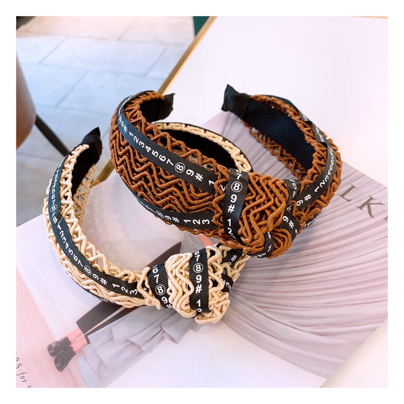 Handmade twisted letter ribbon with knotted headband in the middle