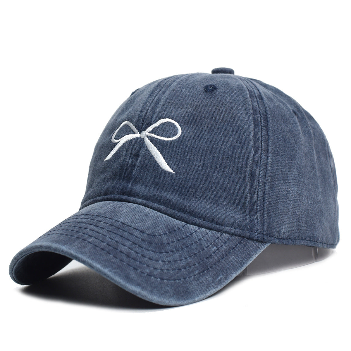 Vasket retro-baseballkasket til kvinder med slidt look og broderet sløjfe