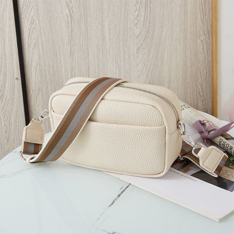 Crossbodytaske med bred skulderrem