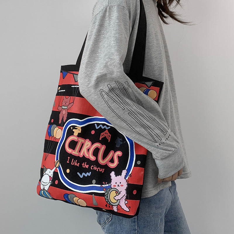 College Students Holding A Stuffed Cloth Bag