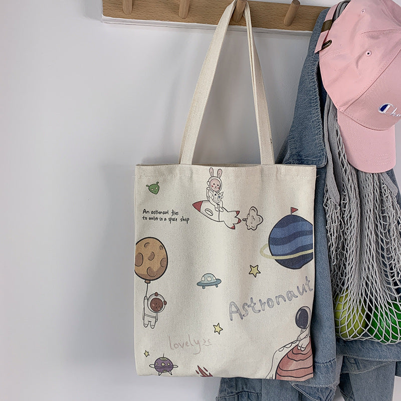 College Students Holding A Stuffed Cloth Bag