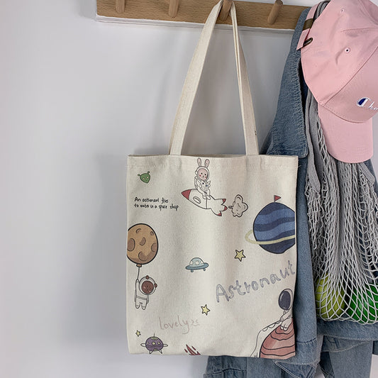 College Students Holding A Stuffed Cloth Bag