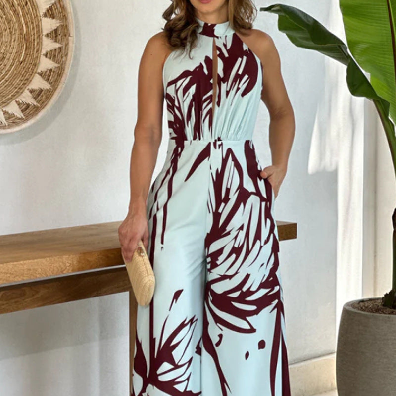 Sommerlig, elegant og moderigtig ærmeløs jumpsuit med halv rullekrave, print, hulmønster og snøret vidde ben
