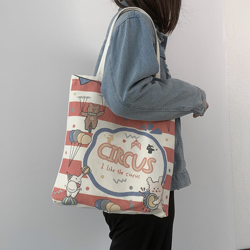 College Students Holding A Stuffed Cloth Bag