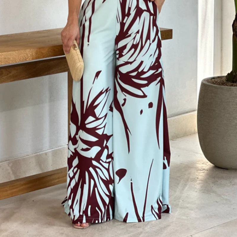 Sommerlig, elegant og moderigtig ærmeløs jumpsuit med halv rullekrave, print, hulmønster og snøret vidde ben